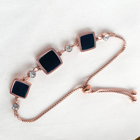 Chic rose gold adjustable bracelet with geometric black square charms and crystals – stylish accessory for contemporary fashion