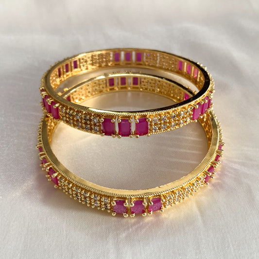 Elegant gold-plated bangles with pink AD stones and CZ accents – luxury jewelry for weddings and special occasions