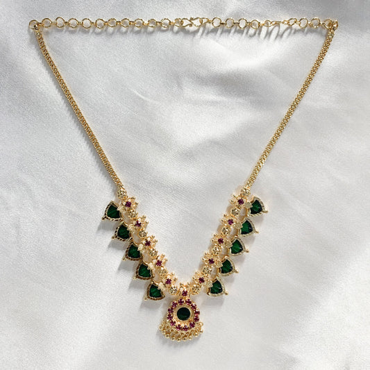 Ethnic gold-plated Palakka necklace featuring vibrant green and pink stones – perfect for traditional occasions and temple wear