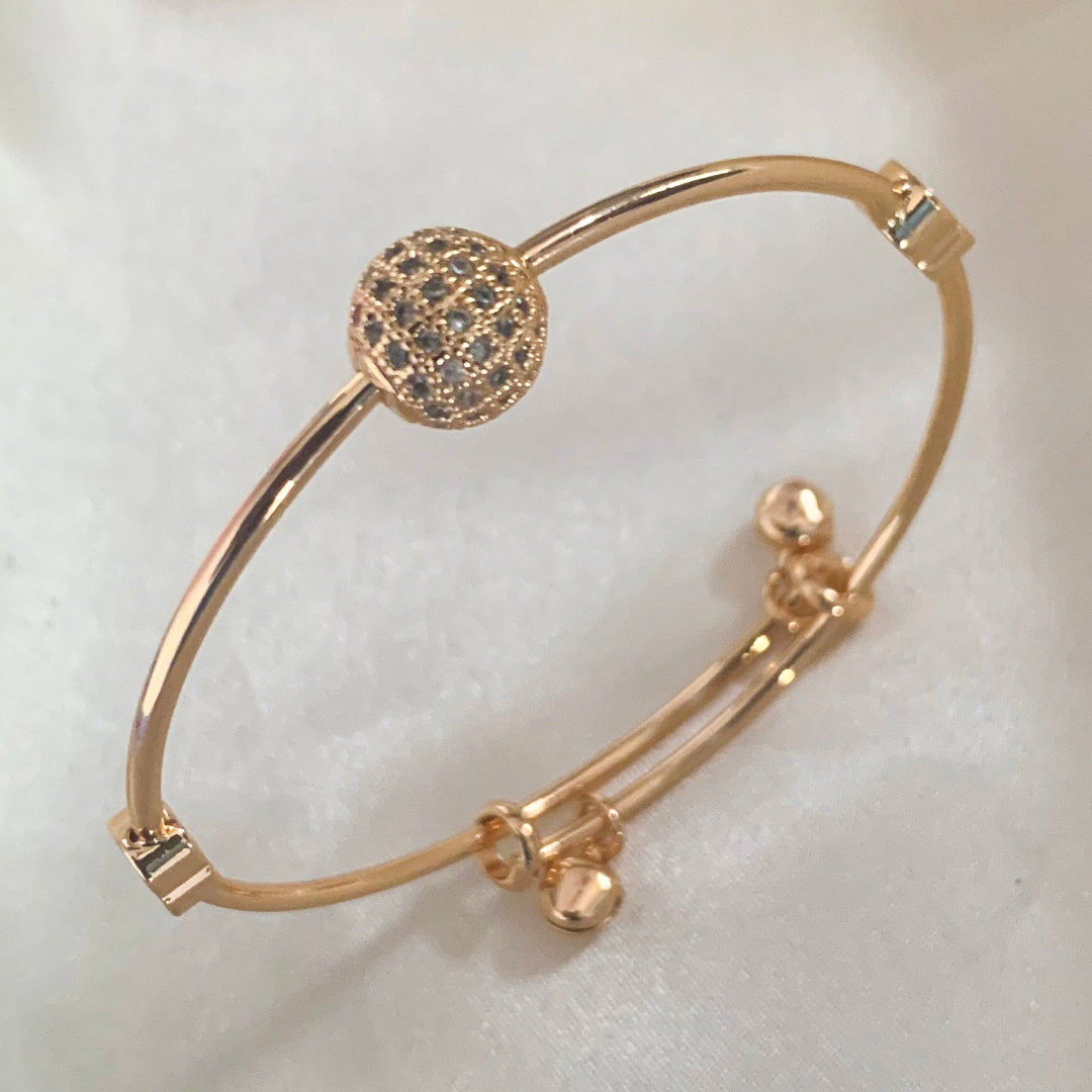 Gold-plated adjustable bangle bracelet featuring heart charms and sparkling crystal bead – perfect for daily styling or gifting