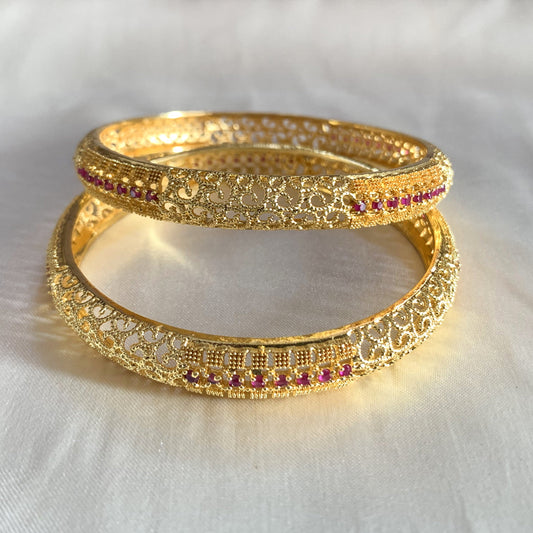 Gold-plated filigree bangles featuring delicate pink stone accents – classic ethnic jewelry for women
