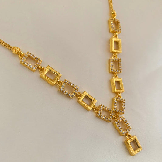 Gold-plated necklace featuring a sleek geometric design and sparkling American Diamond stones – perfect for party and festive wear