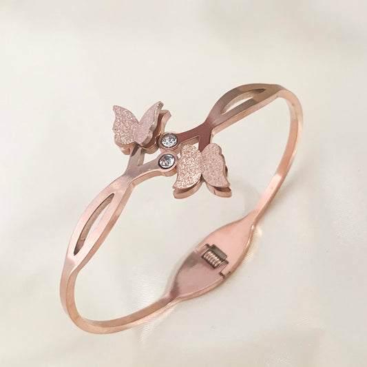 Stylish rose gold bangle bracelet featuring a delicate butterfly motif and sparkling stones – perfect for everyday or festive wear