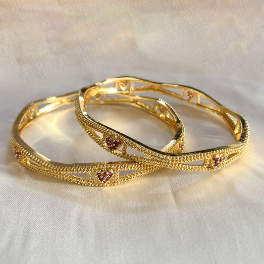 gold-plated bangles featuring delicate pink heart designs – perfect for women’s ethnic and bridal wear