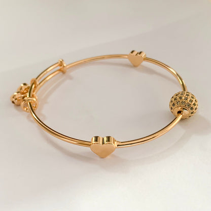 Adjustable gold charm bangle bracelet with crystal bead and heart accents – elegant accessory for women’s casual and festive wear