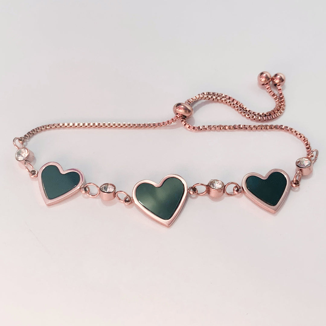 Chic rose gold bracelet featuring black heart-shaped charms and sparkling crystal details