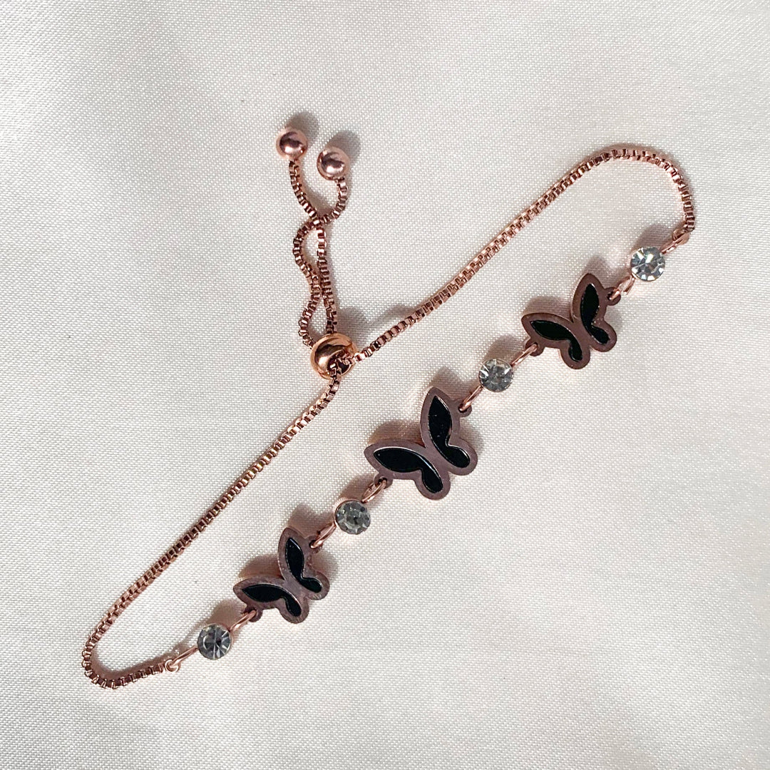 Delicate rose gold bracelet featuring a butterfly charm, black enamel detailing, and crystal highlights – perfect for gifting or casual elegance