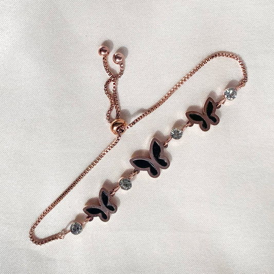 Delicate rose gold bracelet featuring a butterfly charm, black enamel detailing, and crystal highlights – perfect for gifting or casual elegance