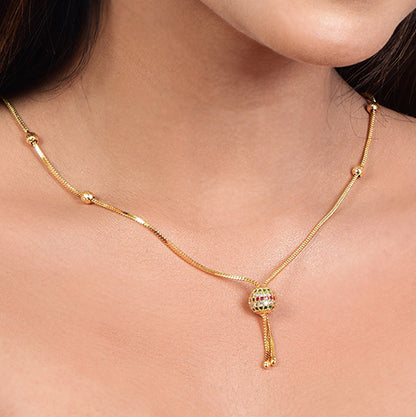 Gold plated necklace with a pendant on a person's neck