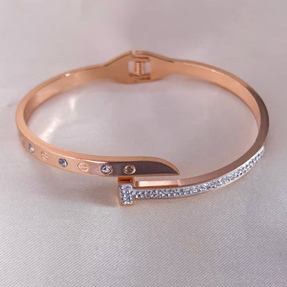 Elegant rose gold bangle featuring a modern nail-inspired design with crystal embellishments – trendy accessory for parties or gifting
