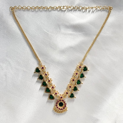 Ethnic gold-plated Palakka necklace featuring vibrant green and pink stones – perfect for traditional occasions and temple wear