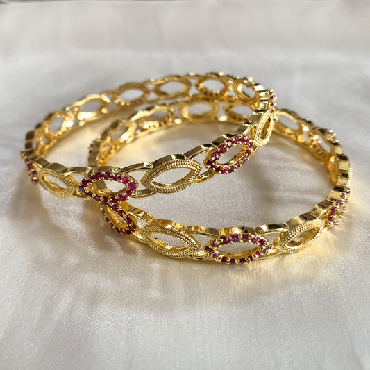Gold-plated bangles with pink crystal accents – lightweight and elegant festive jewelry for women