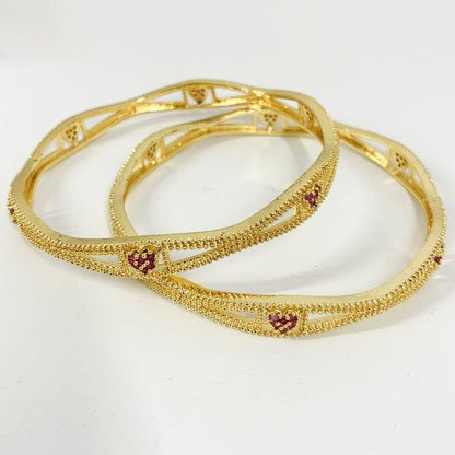 Gold-plated bangles with pink heart motif – elegant ethnic jewelry for festive and special occasions