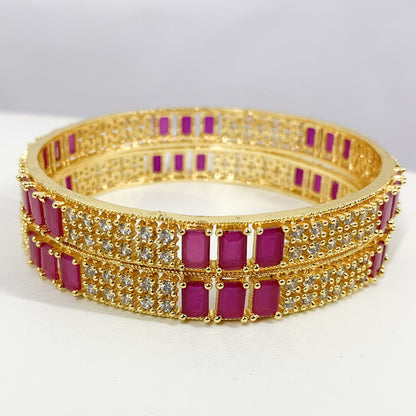 Gold-plated designer bangles featuring pink American Diamonds and shimmering CZ stones – perfect for bridal and festive wear