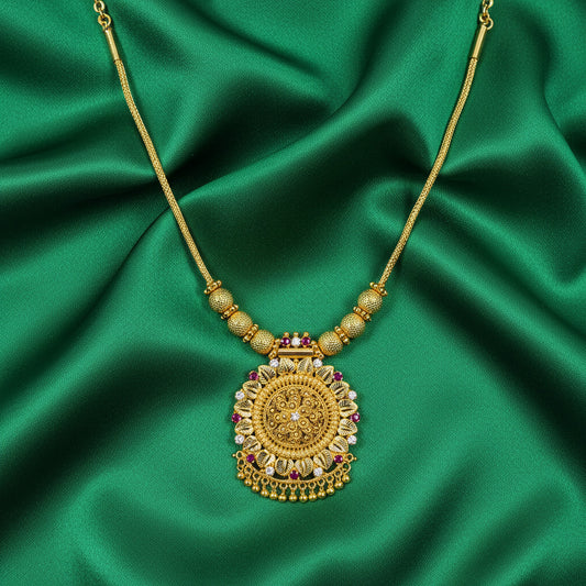 Gold-plated ethnic necklace featuring a detailed pendant and ruby-colored stones – perfect for weddings and traditional occasions