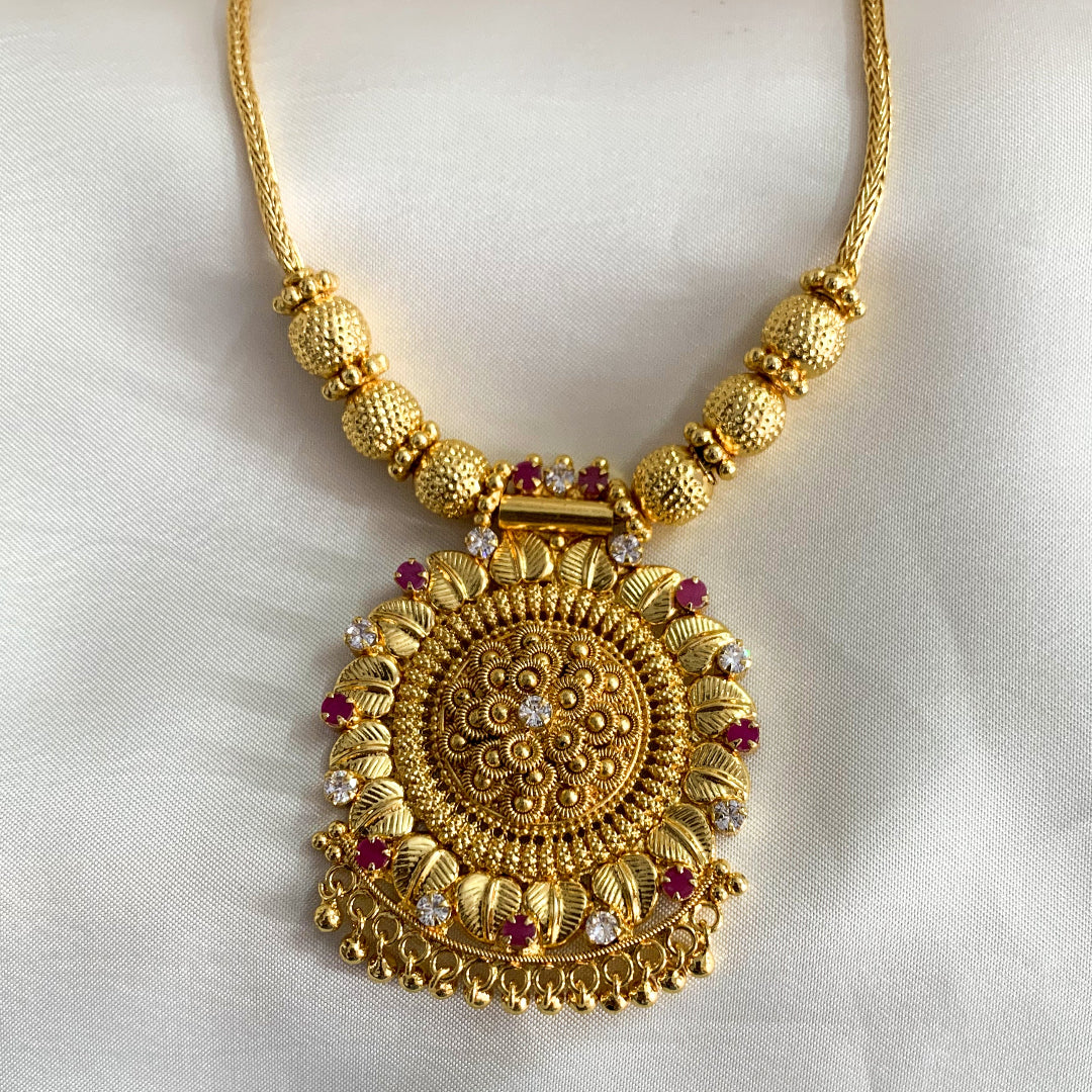 Intricately designed gold-plated necklace with ruby accents – timeless Indian jewelry for women’s cultural celebrations