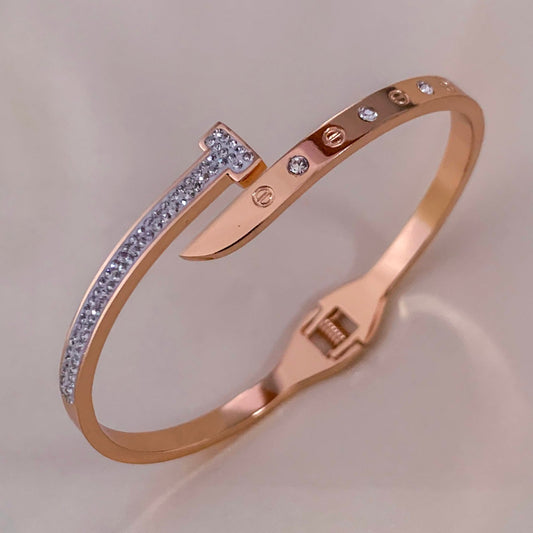 Modern rose gold bangle with crystal nail design and rhinestone accents – stylish statement bracelet for women