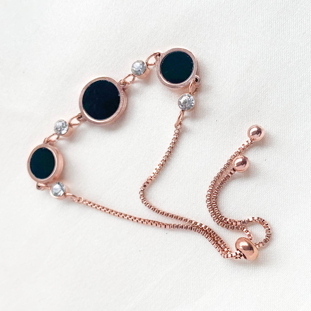 Rose gold adjustable bracelet with black circle charms and crystal detailing – elegant minimalist jewelry for women