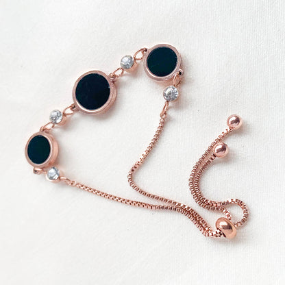Rose gold adjustable bracelet with black circle charms and crystal detailing – elegant minimalist jewelry for women