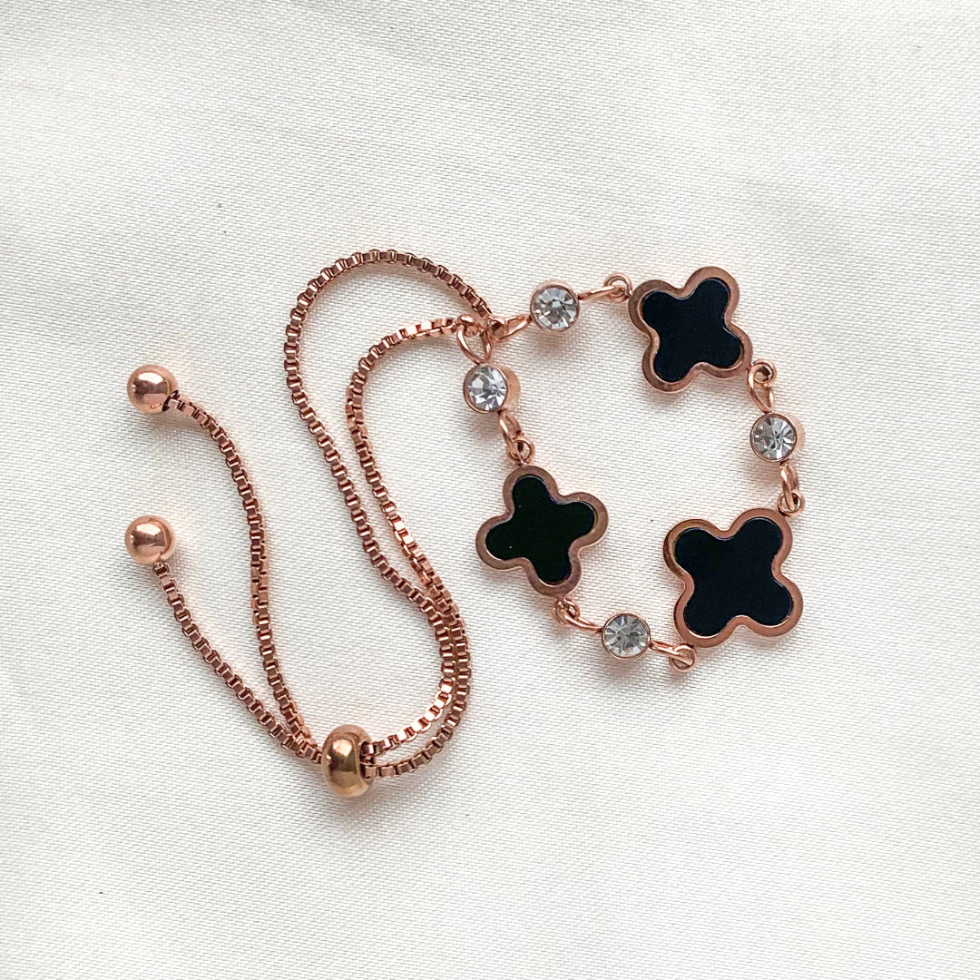 Rose gold adjustable bracelet with black clover charms and crystal accents – elegant good luck jewelry for women