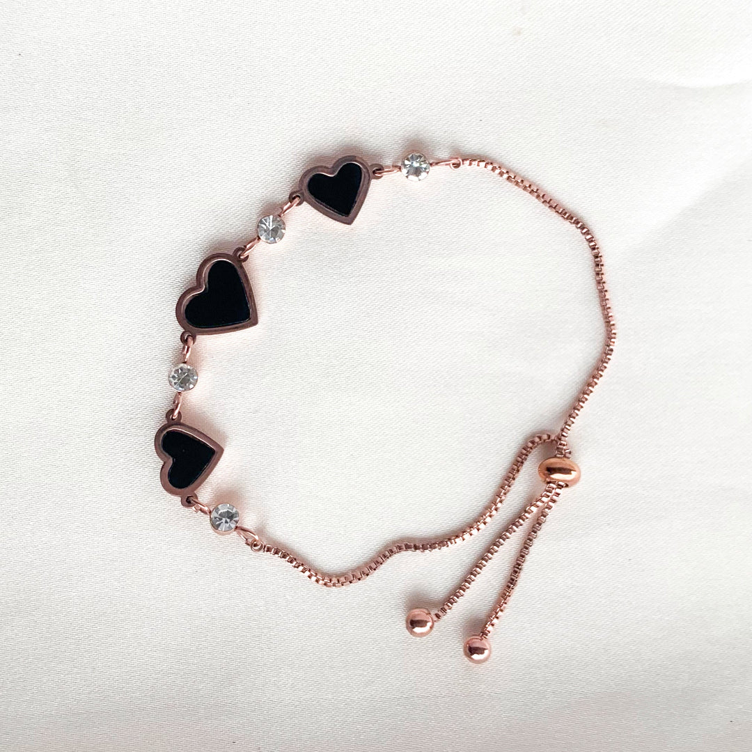 Rose gold adjustable bracelet with black enamel heart charms and crystal accents – elegant romantic jewelry for women