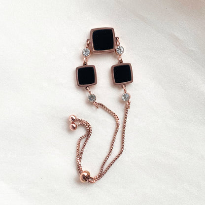 Rose gold adjustable bracelet with black square charms and crystal accents – modern minimalist jewelry for women