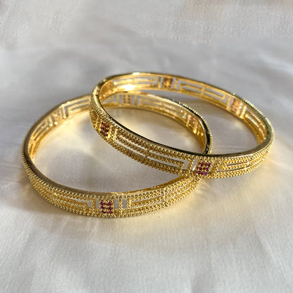 Set of gold-plated bangles featuring ruby-colored stones – perfect for festive, bridal, and ethnic wear