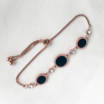 Stylish rose gold bracelet featuring black enamel circle charms and sparkling crystals – perfect for modern everyday wear