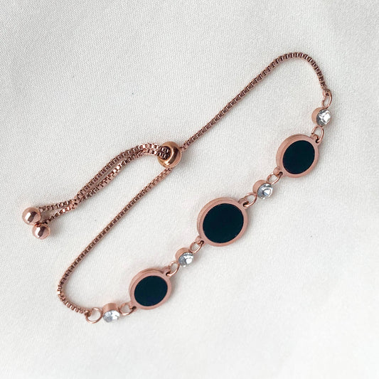 Stylish rose gold bracelet featuring black enamel circle charms and sparkling crystals – perfect for modern everyday wear