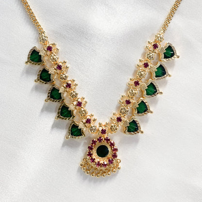 Traditional Palakka gold-plated necklace with green and pink stones – classic South Indian jewelry for festive and bridal wear