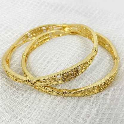Traditional gold-plated bangles with criss-cross filigree work and white stones – ethnic jewelry for women
