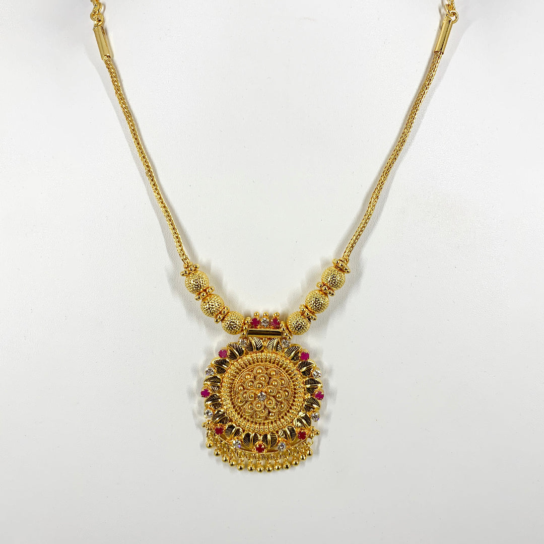 Traditional gold-plated necklace with intricate pendant and ruby accents – ethnic Indian jewelry for festive and bridal wear