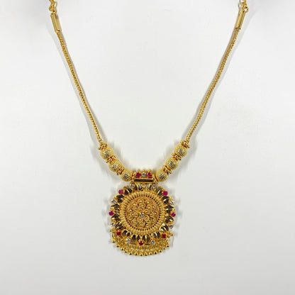 Traditional gold-plated necklace with intricate pendant and ruby accents – ethnic Indian jewelry for festive and bridal wear